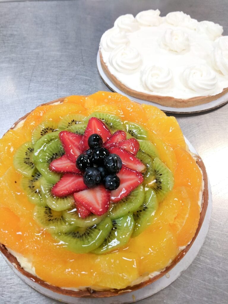 A fruit tart and a banana cream tart 