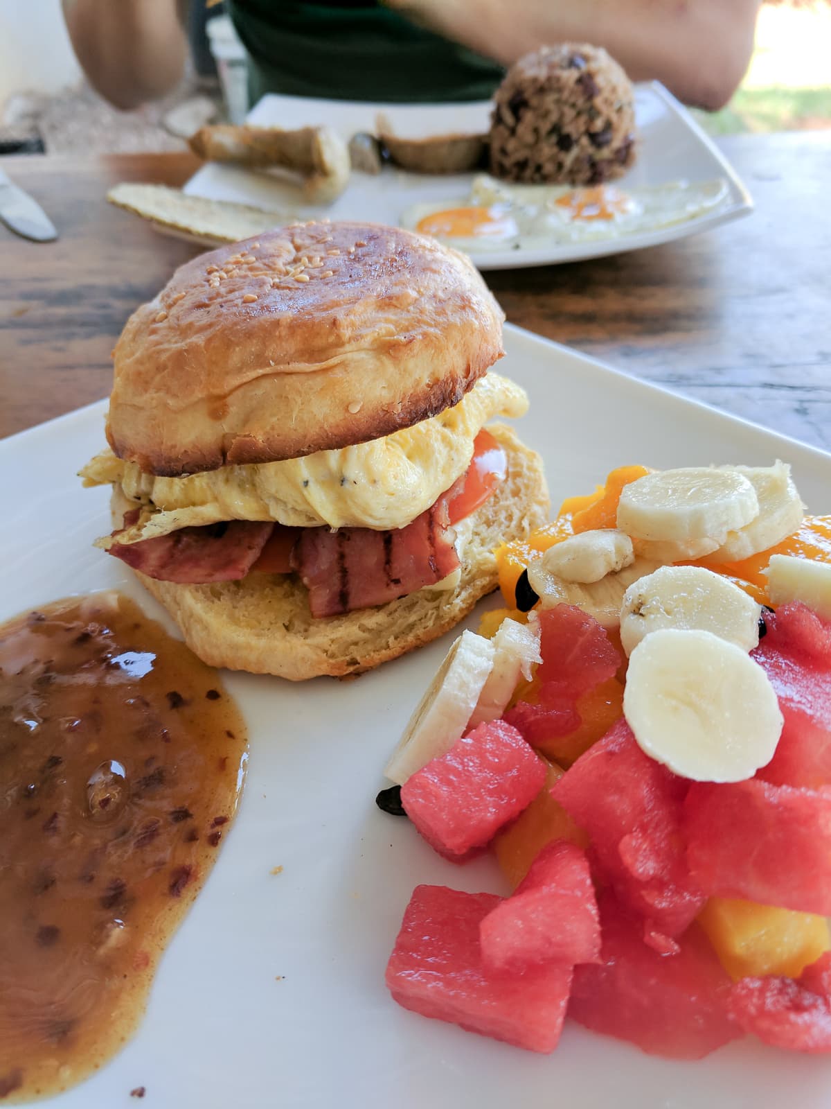 Breakfast at La Bodega: egg and bacon sandwich with fruit