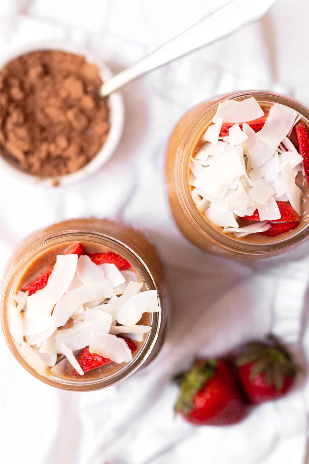 Two glasses of chocolate banana smoothie viewed from overhead