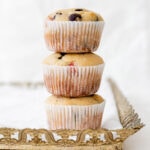 Stack of strawberry chocolate chip muffins on top of a gold tray