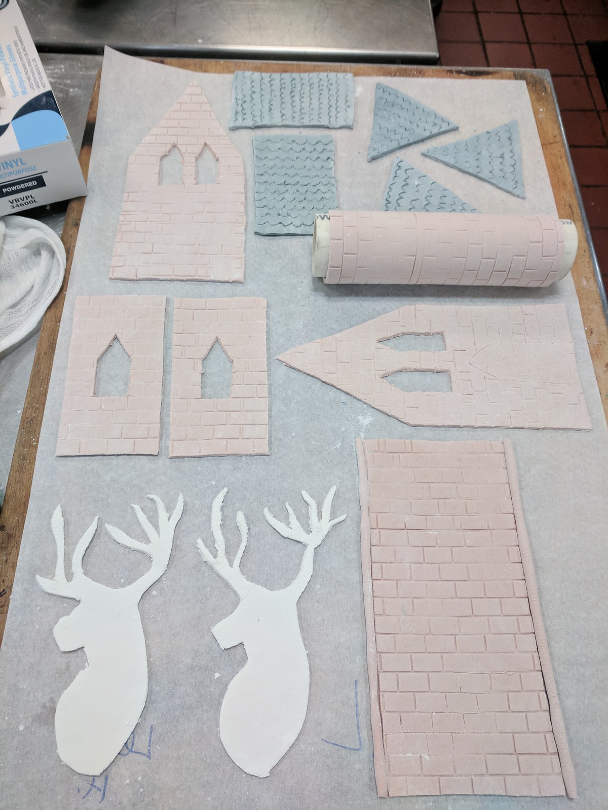 Various pieces of pastillage laid out on a wooden board