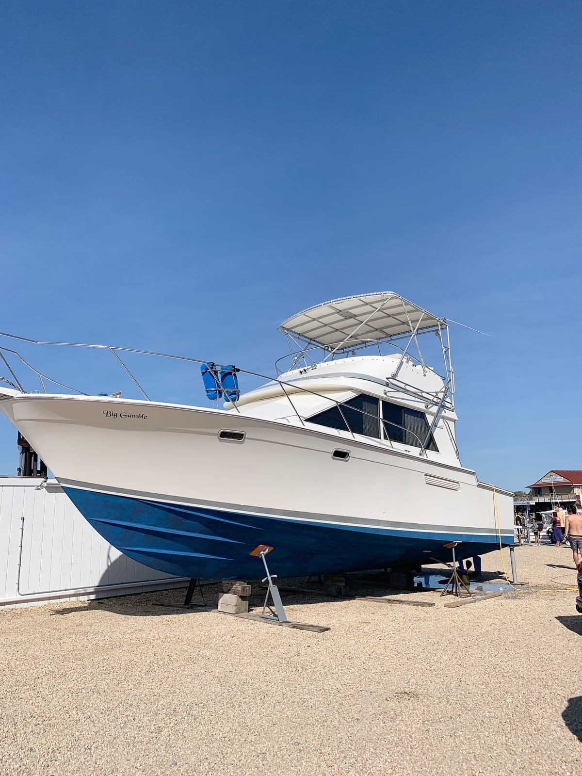 Large boat sitting ashore in front of a blue sky