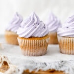 Cake stand topped with Earl Grey lavender cupcakes on a grey napkin