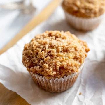 Banana crumb muffins on a cutting board with parchment paper
