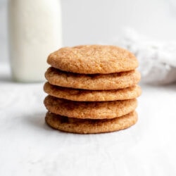 Stack of vegan snickerdoodles in front of a glass of milk