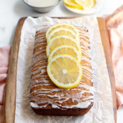 Earl Grey and lemon loaf cake on a cutting board lined with parchment paper