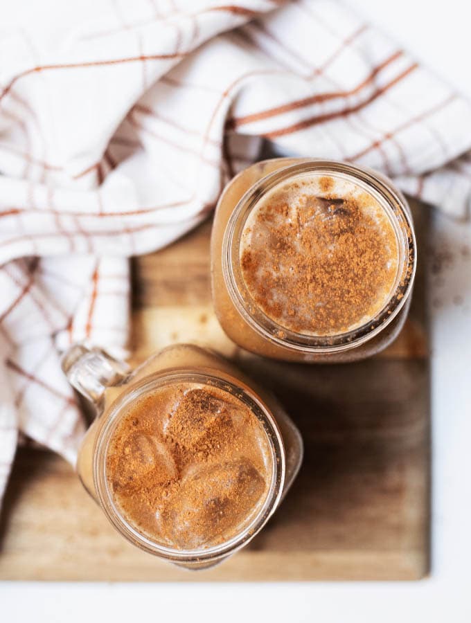 Two glasses of pumpkin cream cold brew viewed from top down