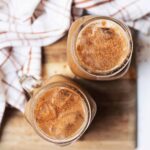 Two glasses of pumpkin cream cold brew viewed from top down