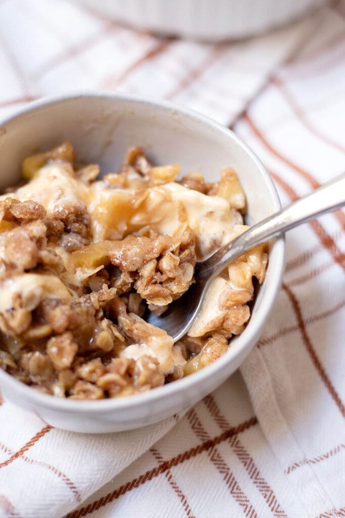 Bowl with apple crisp and ice cream mixed together