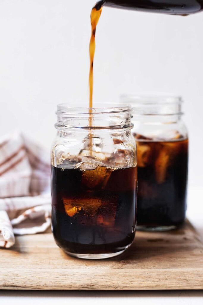 Two glasses of cold brew being poured