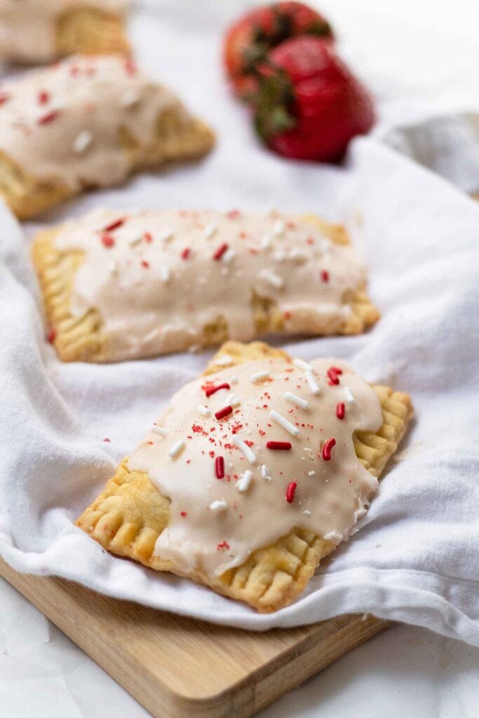Strawberry pop tarts on top of a cutting board