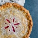 Overhead shot of a cranberry pie resting on a napkin