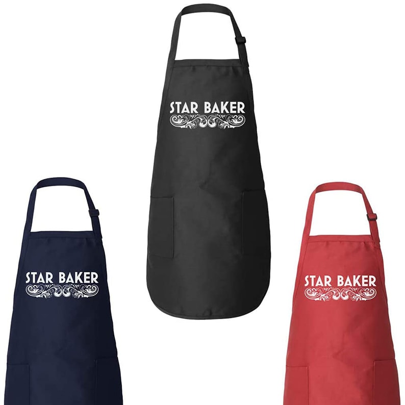 Black, red, and blue aprons that read 'Star Baker'