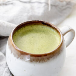 Mug with oat milk matcha latte with text that reads 'Oat Milk Matcha Latte'