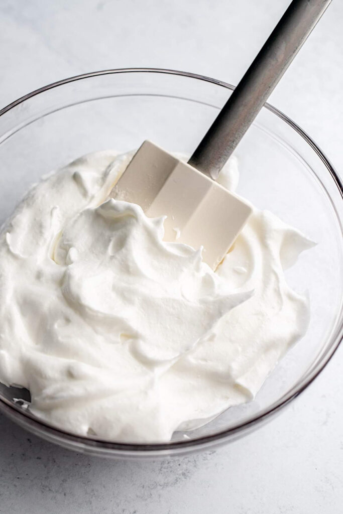 Bowl of meringue with a spatula resting in it