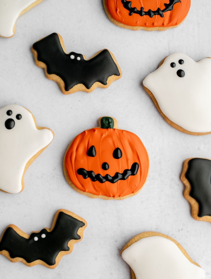 Pumpkin, bat, and ghost cookies decorated with royal icing