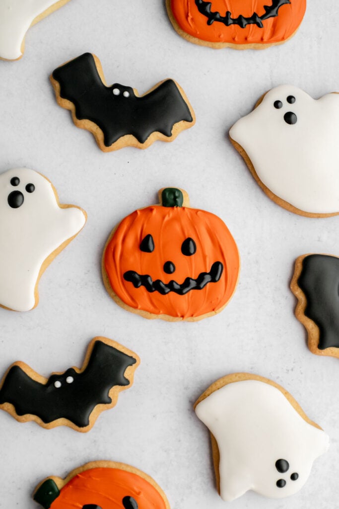 Pumpkin, bat, and ghost sugar cookies decorated with royal icing