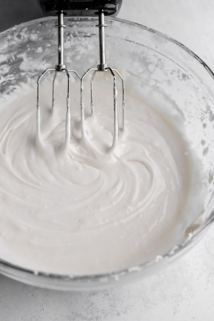 Bowl of royal icing with whisk