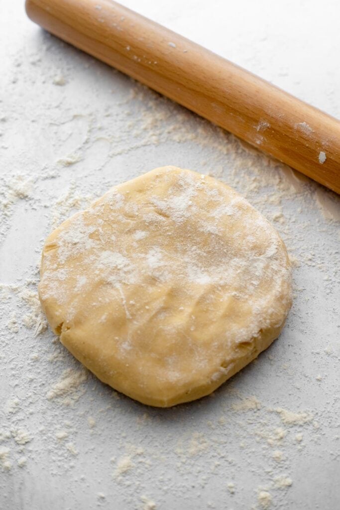 Rolling out sugar cookie dough with a French rolling pin