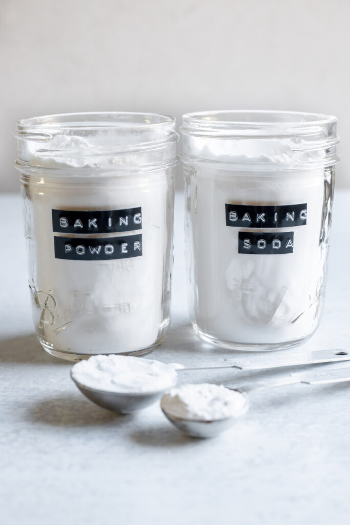 Two glass jars labeled 'Baking Powder' and 'Baking Soda' 