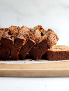 Slices of banana bread leaning on a cutting board