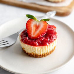 Mini strawberry cheesecake on a plate with a fork