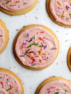 Sugar cookies with pink frosting and sprinkles